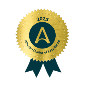 Logo_Center-of-Excellence-2025 - Instituto de Obesidad Gold award ribbon badge with a teal center featuring a stylized A and the year 2025; text around edge reads Center of Excellence (award seal).